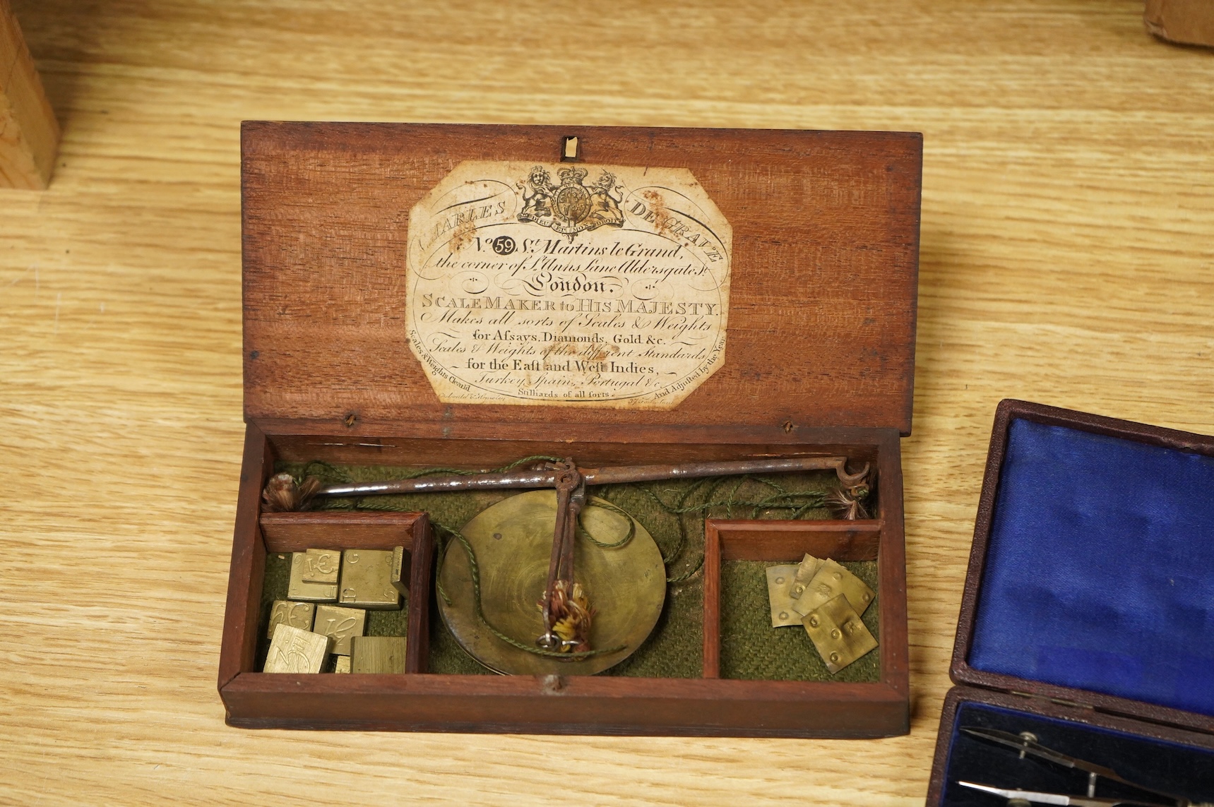 Four scientific instruments, consisting; a set of apothecaries steel balance scales, by Charles de Grave, 59, St. Martin’s le Grand…London; a set of three small drawing compasses, leather cased; a prismatic compass, by S